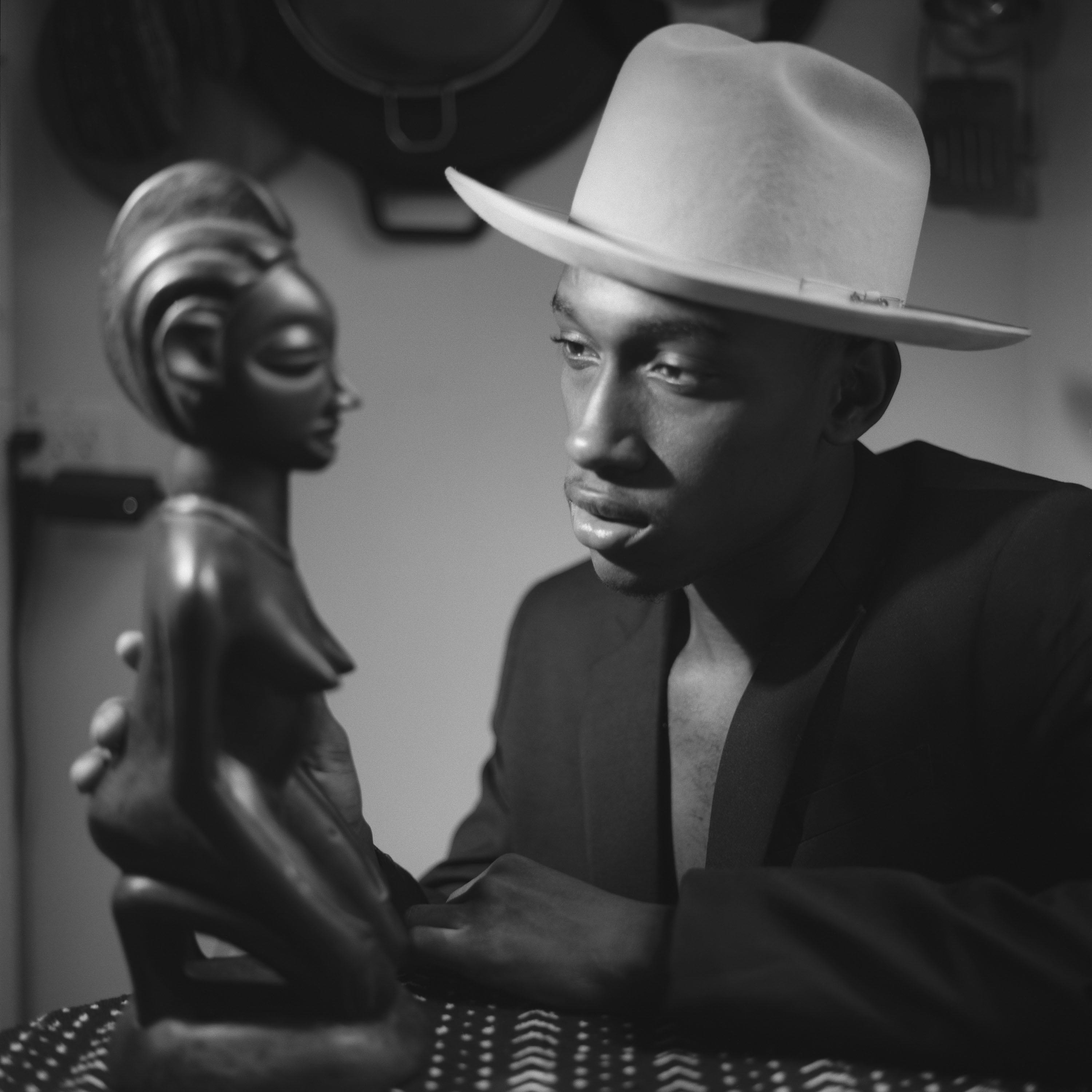 Young man looking at female sculpture from the Senufo 2019 C John Edmonds