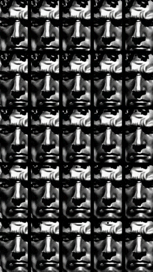 Moving image of multiple greek-like statues in black and white, slowly zooming out
