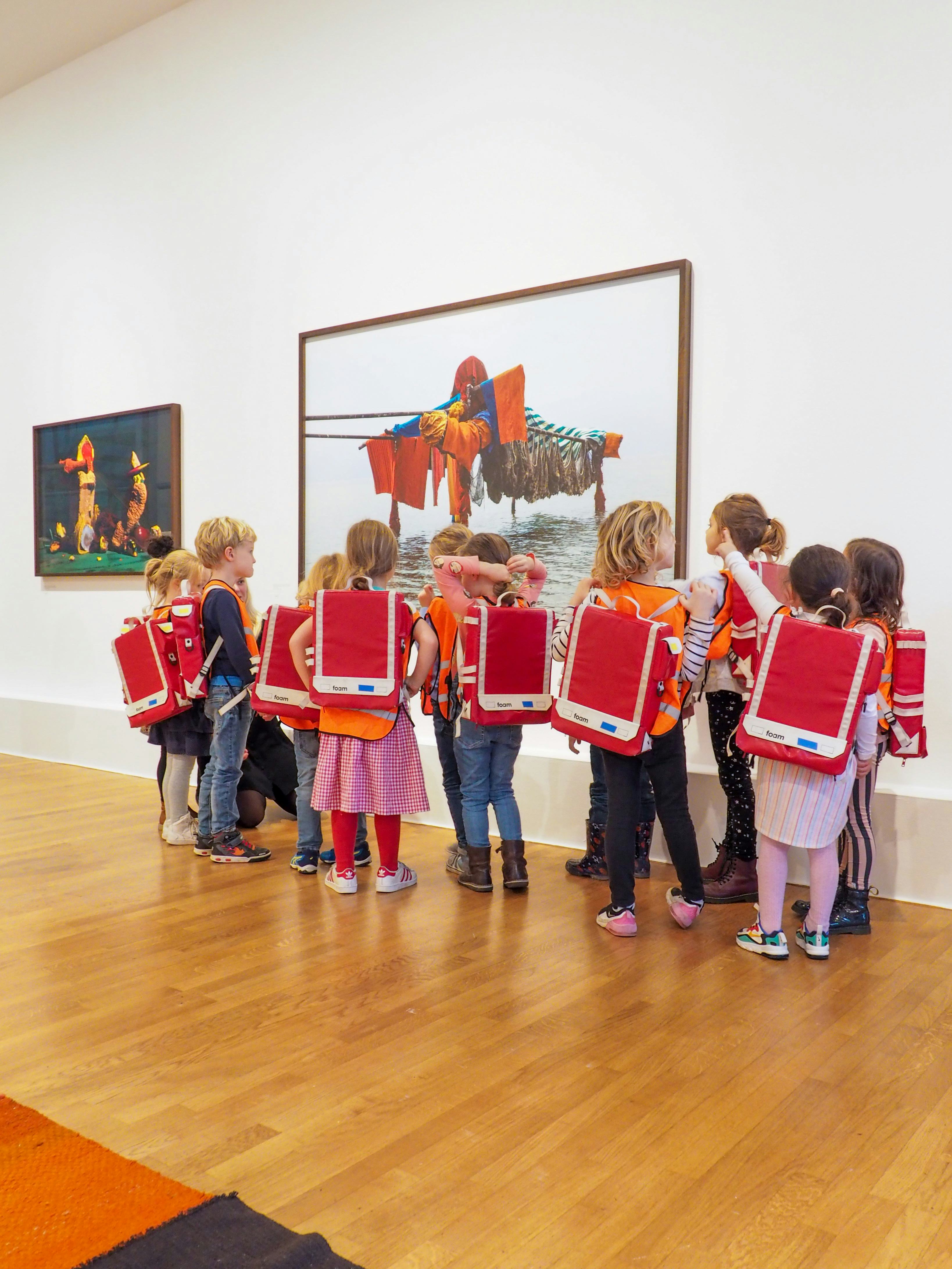 A group of young kids in the museum space at Foam
