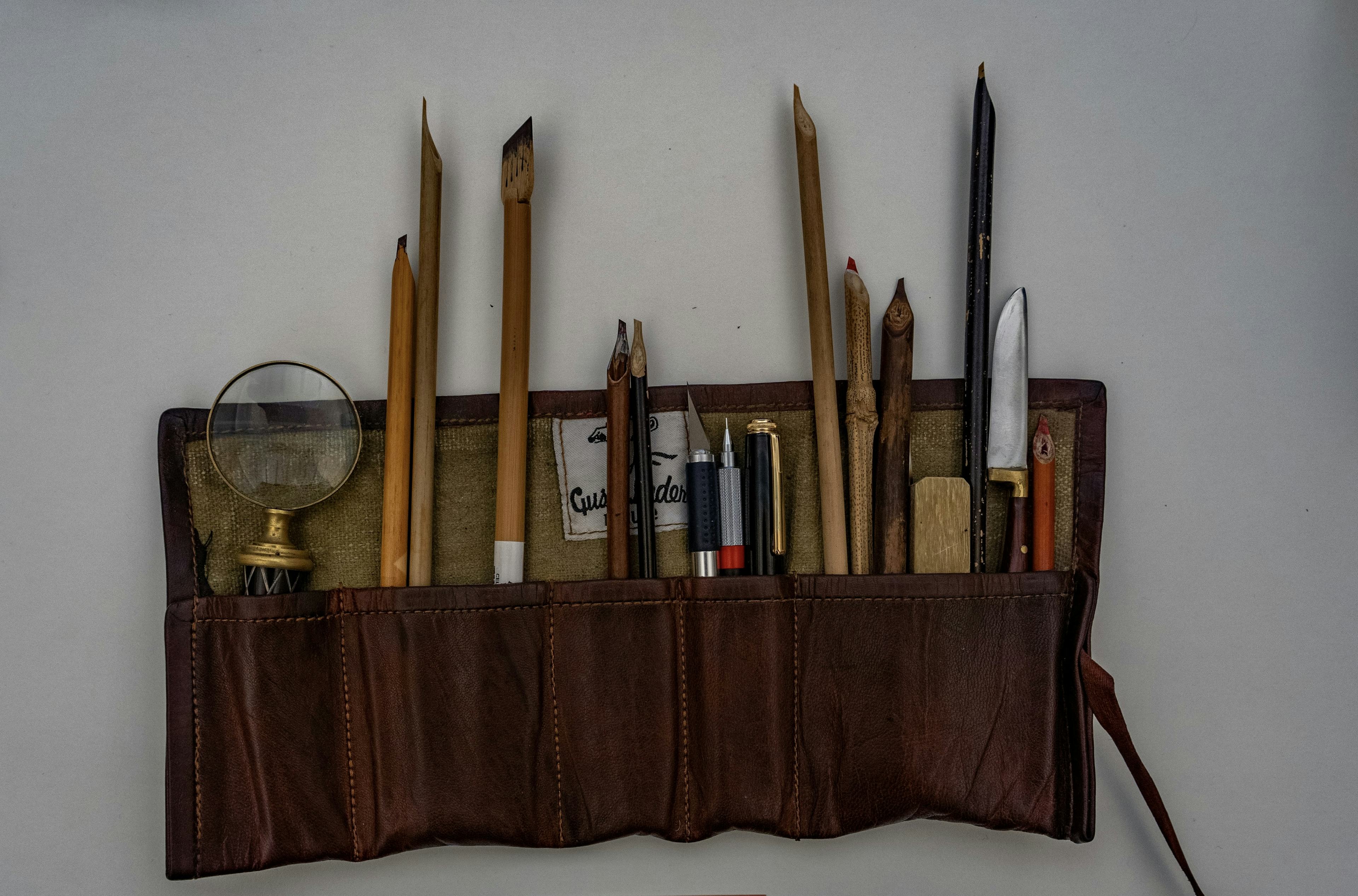 Arabic calligraphy tool set in a brown tool case