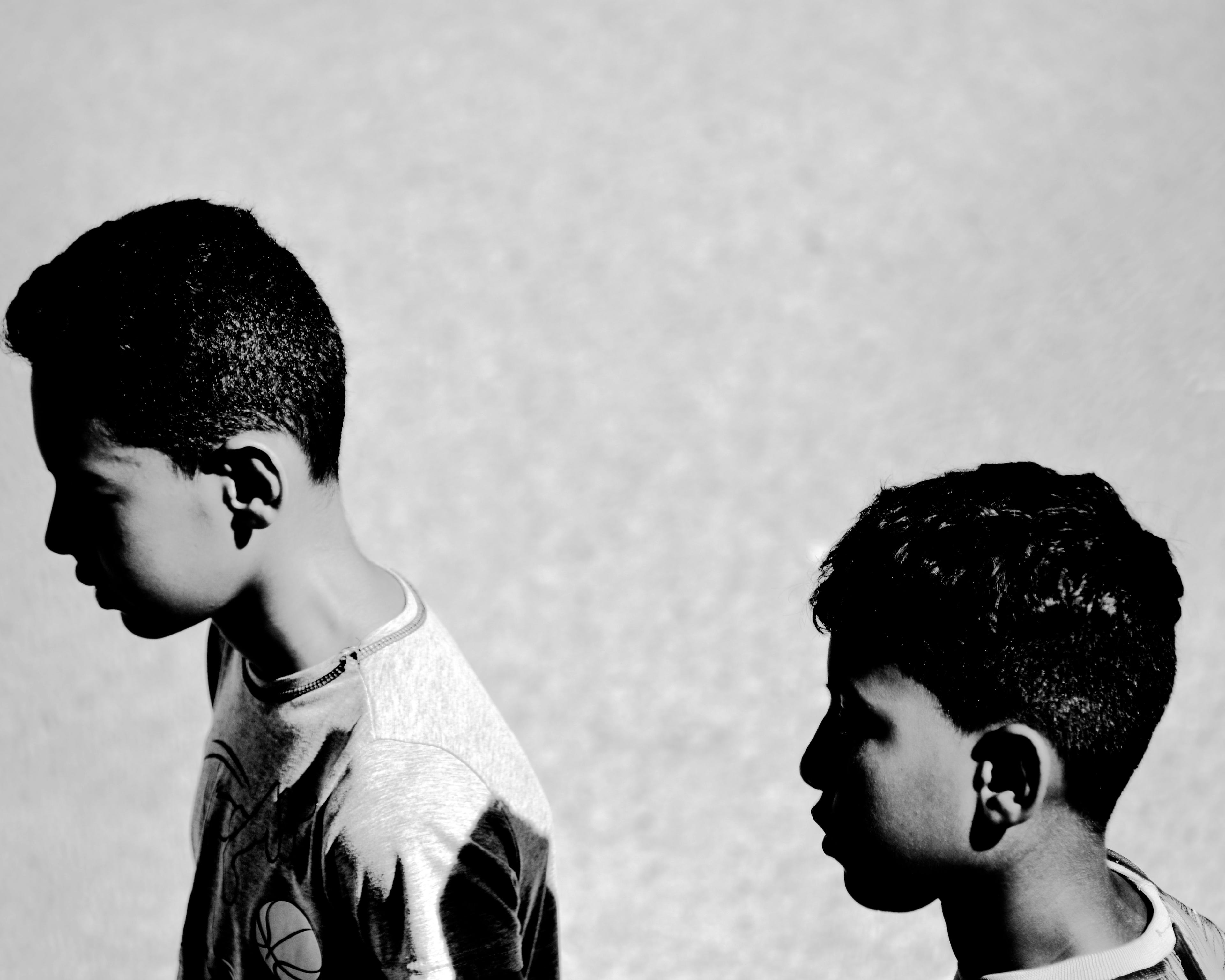 Black and white image of two young boys on the street. © Issam Larkat