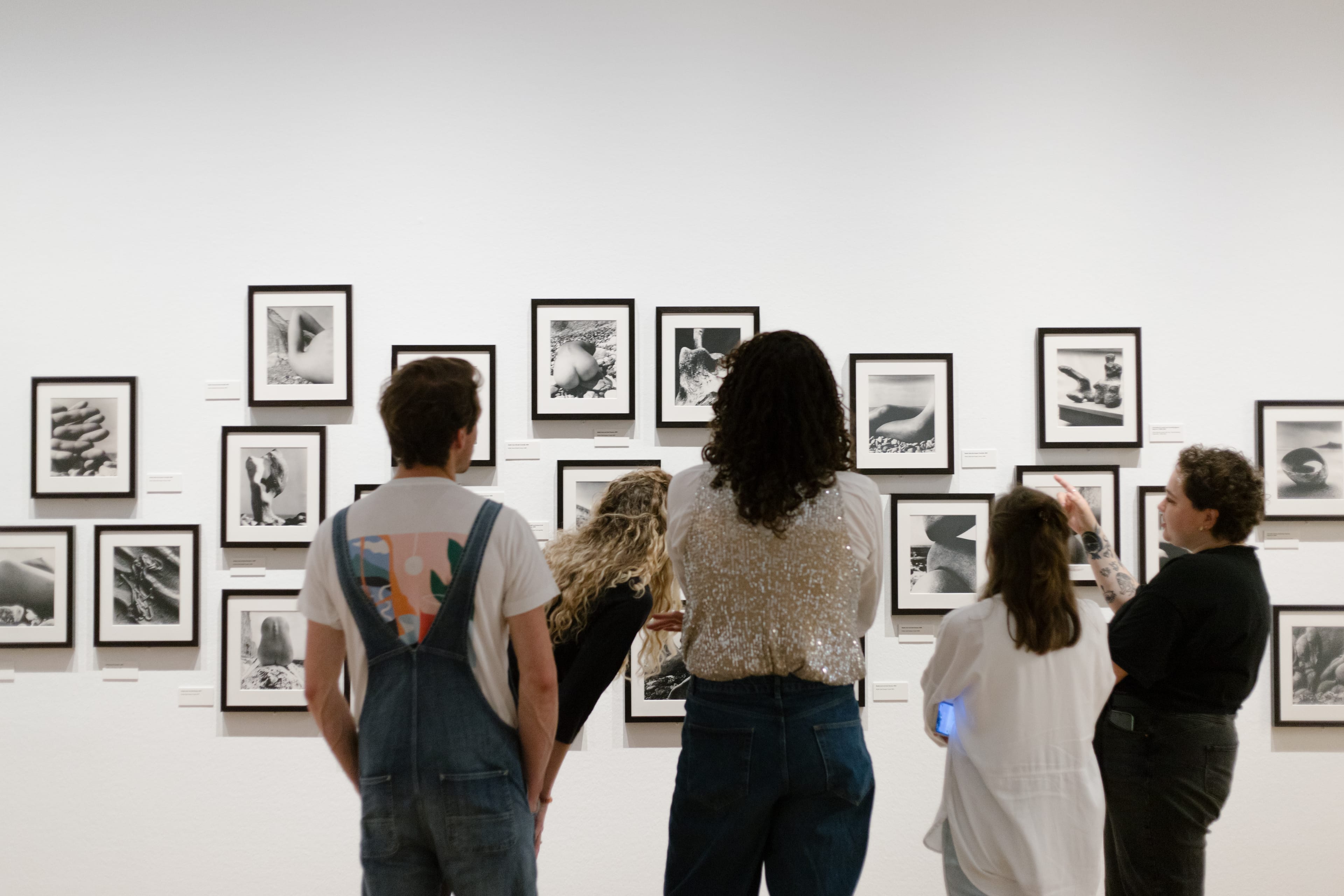 Group of students are watching photographs together with a museum teacher