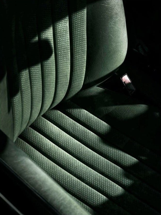 A closeup of green car seat with a lot of shadows