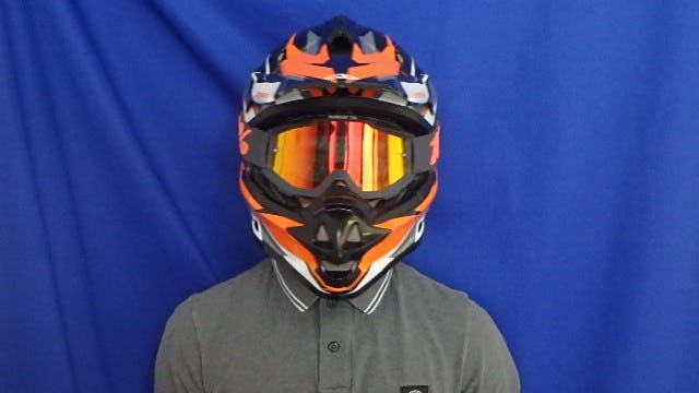 Person with a motor helm in front of a blue background